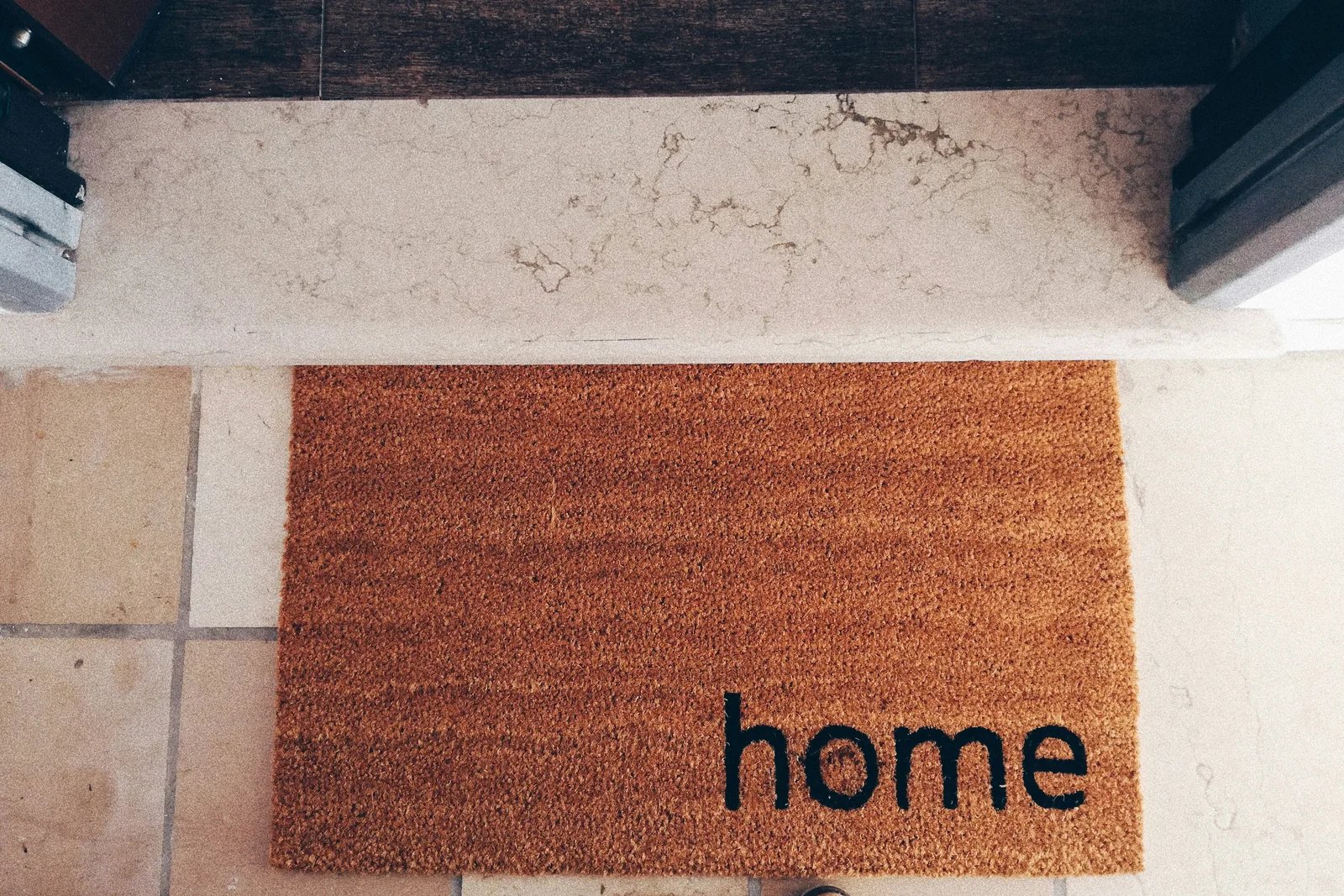 A home doormat at an open doorway