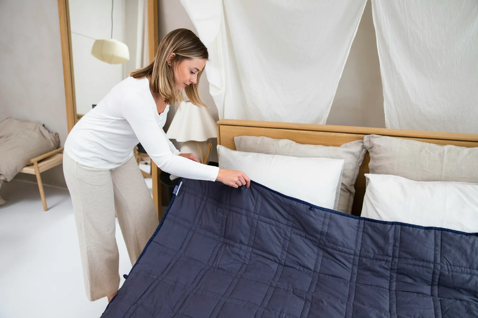 A freshly prepared bed in a calm, light-filled room