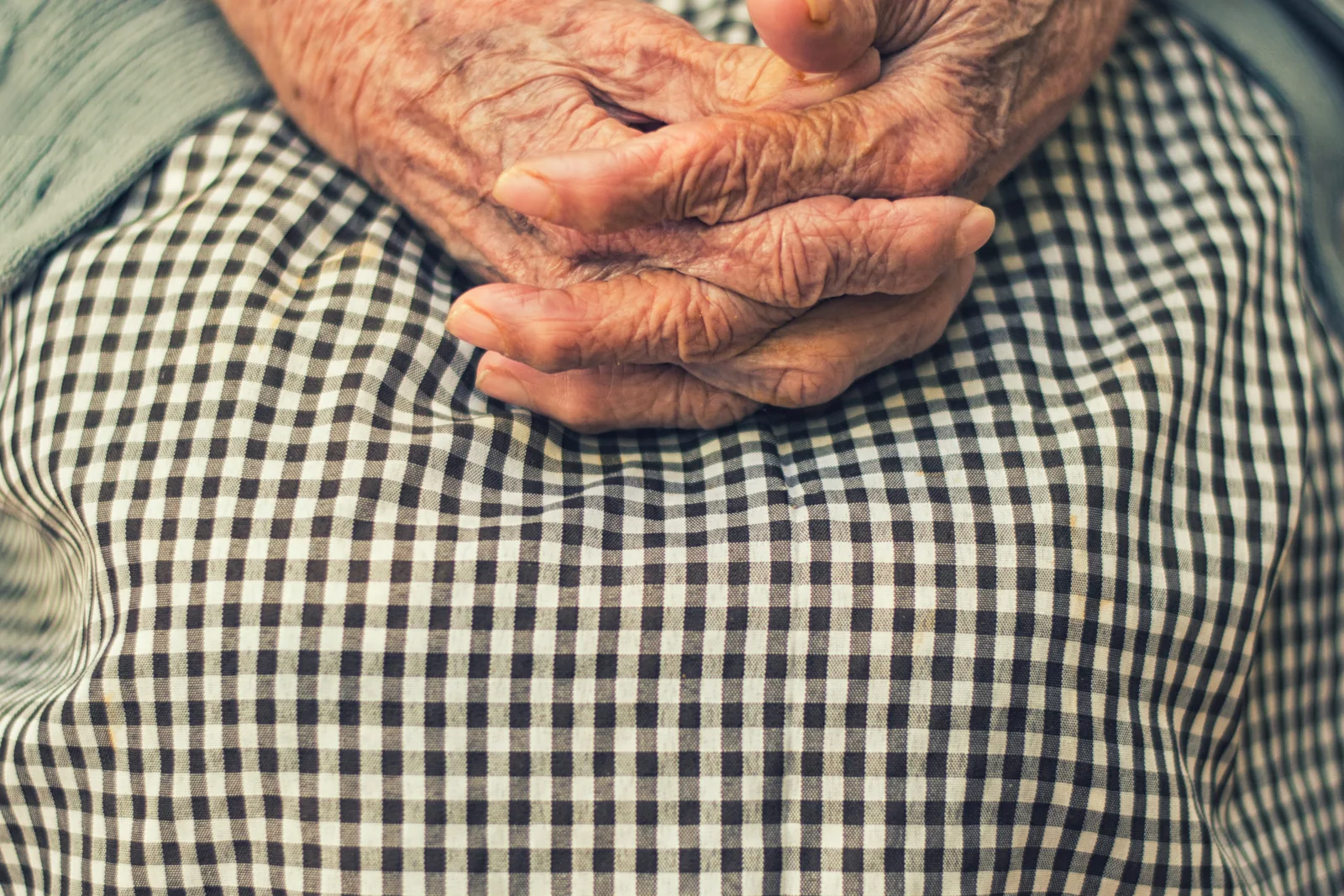 An older adult’s hands resting gently together
