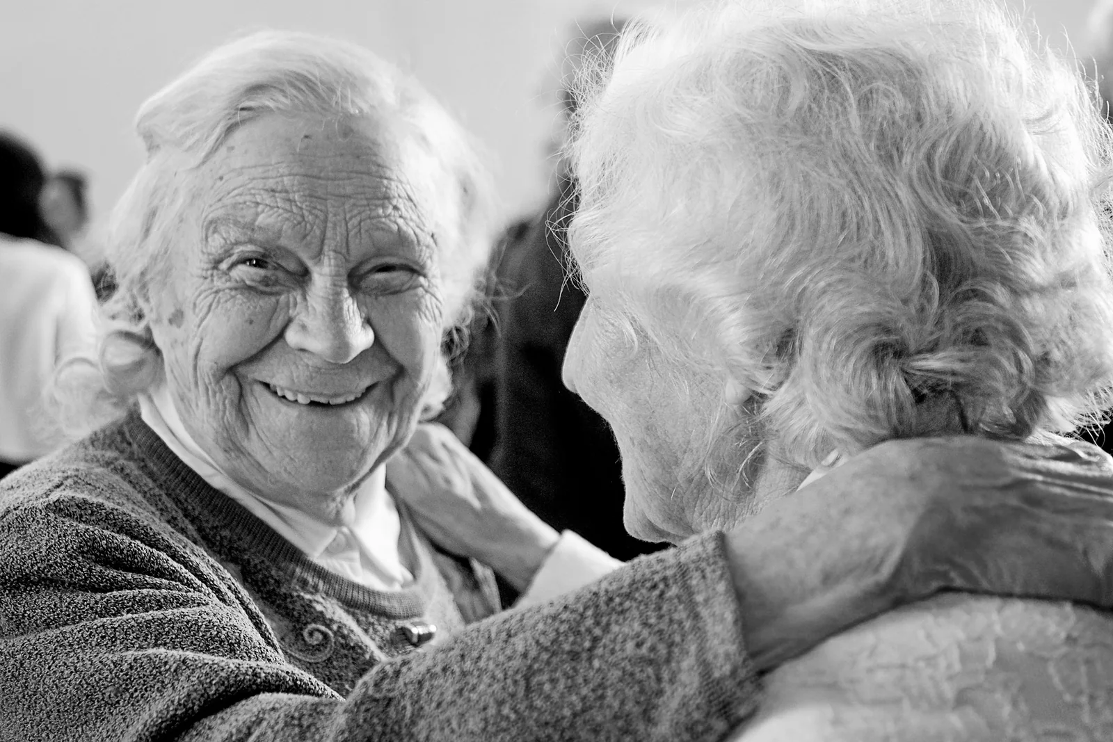 Two older friends smiling warmly together