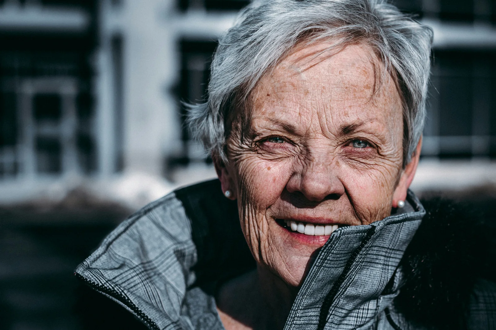 A smiling older woman looking directly at the camera
